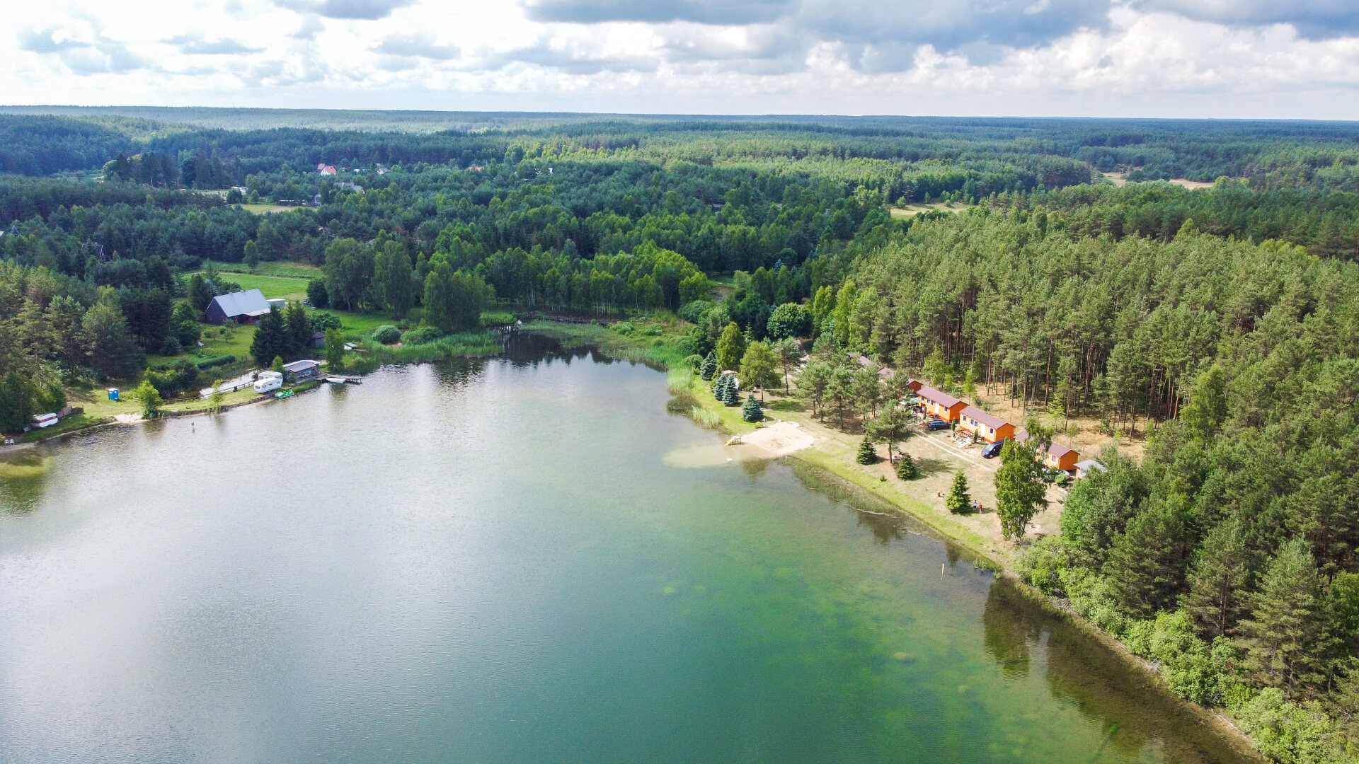 Agroturystyka Kaszuby i Bory Tucholskie - widok na domki, jezioro i lasy